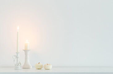 white burning candles on background white wall