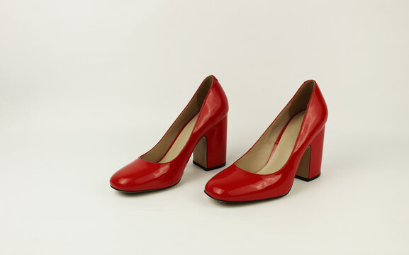 red women's patent leather shoes on a white background