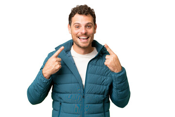 Brazilian man over isolated chroma key background giving a thumbs up gesture