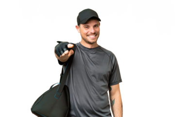 Young sport man with sport bag over isolated chroma key background points finger at you with a confident expression