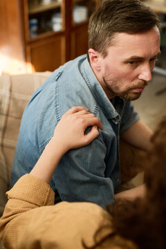 Vertical image of young woman supporting man at psycho session