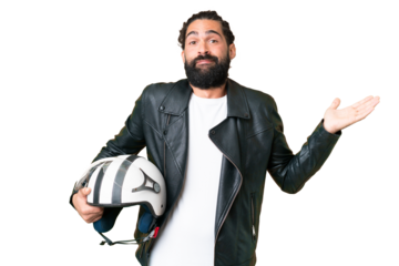 Young man with beard with a motorcycle helmet over isolated chroma key background having doubts while raising hands