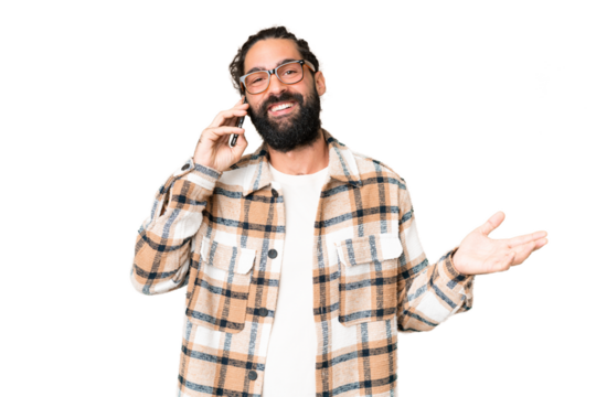 Young man with beard over isolated chroma key background keeping a conversation with the mobile phone with someone