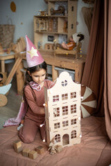 little girl dressed as a sorceress in a scandinavian children's room. © Маргарита Медведева