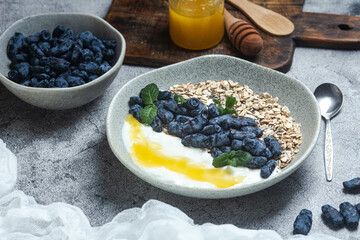Oatmeal with yogurt and honeysuckle in a bowl