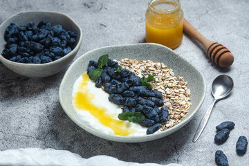 Oatmeal with yogurt and honeysuckle in a bowl