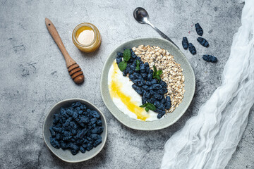 Oatmeal with yogurt and honeysuckle in a bowl