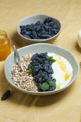 Oatmeal with yogurt and honeysuckle in a bowl