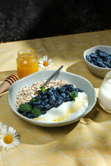 Oatmeal with yogurt and honeysuckle in a bowl