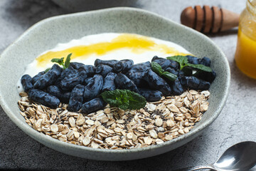 Oatmeal with yogurt and honeysuckle in a bowl
