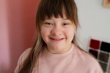 Sunny smiling girl close-up portrait World day of people with down syndrome