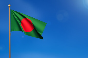 Bangladesh. Flag blown by the wind with blue sky in the background