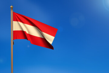 Austria. Flag blown by the wind with blue sky in the background