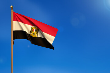 Egypt. Flag blown by the wind with blue sky in the background