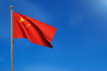 China. Flag blown by the wind with blue sky in the background