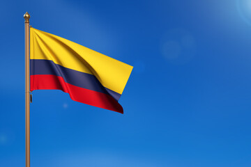 Colombia. Flag blown by the wind with blue sky in the background