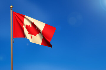 Canada. Flag blown by the wind with blue sky in the background