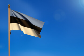 Estonia. Flag blown by the wind with blue sky in the background