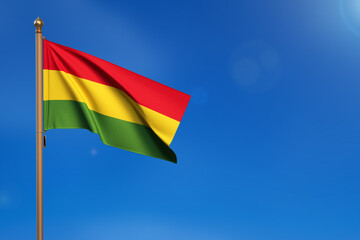 Bolivia. Flag blown by the wind with blue sky in the background