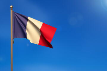 France. Flag blown by the wind with blue sky in the background