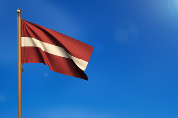 Latvia. Flag blown by the wind with blue sky in the background