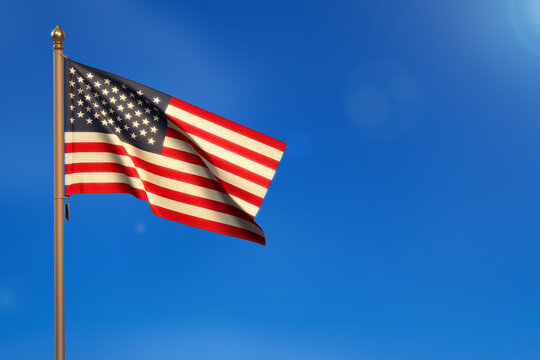 USA. United States. Flag blown by the wind with blue sky in the background
