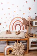 Child's room interior with rainbow painting on wall