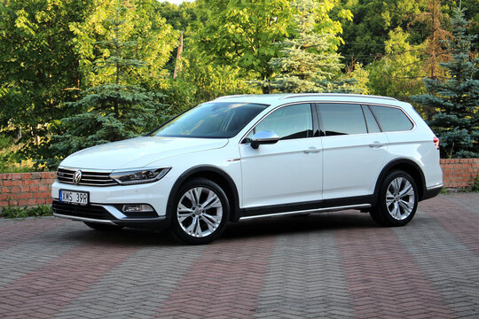 Vinnytsia, Ukraine; June 15, 2023. White Volkswagen Passat Alltrack at the parking. German Volkswagen Passat Wagon on the background of green nature. Front  left view.