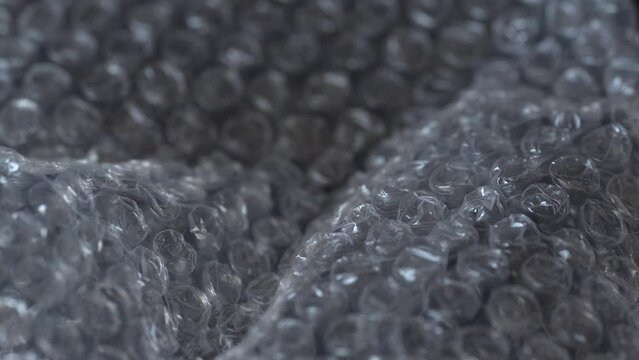 Transparent plastic bubble wrap, abstract background, close up footage with movement. High quality 4k footage
