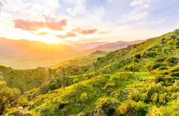 green highland mountain landscape of beutiful sunset or sunrise in greeen summer rural land