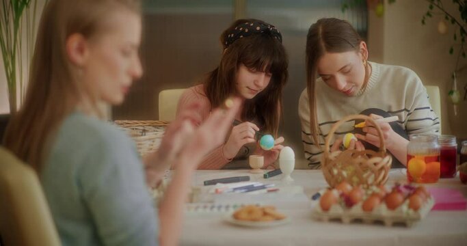 Sisters Painting Easter eggs for Easter Holidays