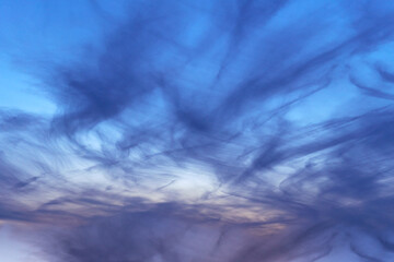 Dramatic dark blue sky with streaks of clouds