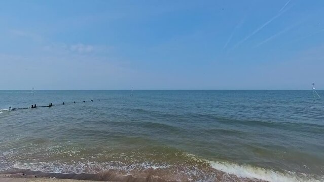 Pull back shot of the view captured from the promenade in the coastal town of Hunstanton on the North Norfolk coast. Captured on a bright and sunny summer day