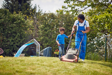 Grass-Cutting Bond: Afro-American Father and Son Forge Memories with Every Mow