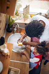 Dishwashing Duo: Afro-American Father and Daughter United in Cleaning