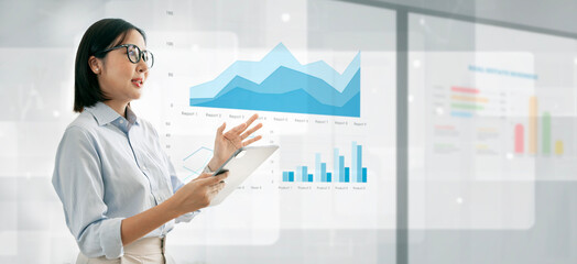 Young businesswoman making a presentation speech. Business woman standing explaining chart and...
