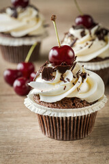 cupcake with vanilla cream and cherry.
