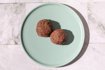 Georgian beetroot phali or pkhali with walnuts, garlic and spices on black plate
