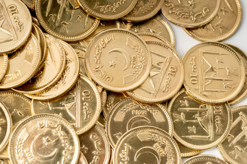 Stacks of gold coins of Pakistani currency symbolize wealth and prosperity