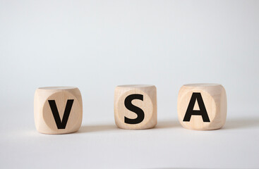 VSA - Volume Spread Analysis symbol. Wooden cubes with word VSA. Beautiful white background. Business and Volume Spread Analysis concept. Copy space.