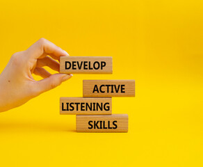 Listening skills symbol. Concept word Develop active listening skills on wooden blocks. Beautiful...