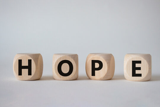 Hope symbol. Concept word Hope on wooden cubes. Beautiful white background. Business and Hope concept. Copy space.