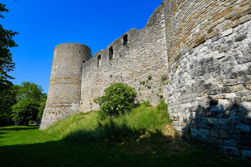 Fototapeta na wymiar Low-angle view of the walls of the medieval castle of Yèvre le Châtel and its four round corner towers in the department of Loiret, France