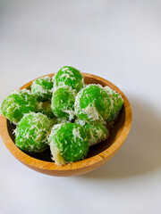 Kelepon or Klepon is a traditional Indonesian food made from glutinous rice flour filled with brown sugar and sprinkled with grated coconut.