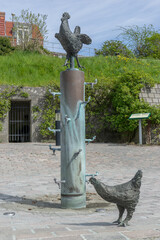 Bronze sculpture with rooster and chickens Source Hønekilden in Sønderborg - Denmark