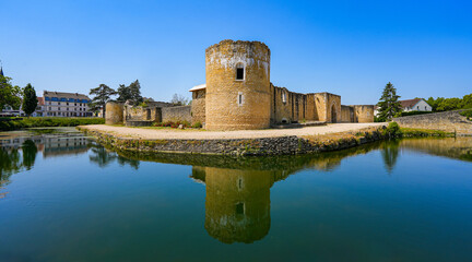 Reflection of the round corner tower of the medieval castle of Brie Comte Robert in the water-filled moat in the French department of Seine et Marne in the capital region of Ile-de-France near Paris - obrazy, fototapety, plakaty