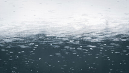 Raindrops on water surface. Raindrops falling on teal colored water. Minimal background.