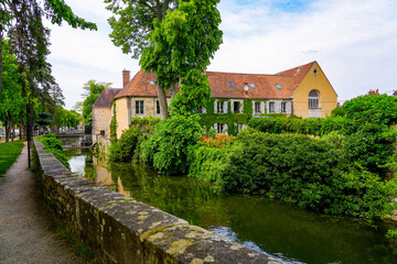 Fototapeta na wymiar Mansion built along the Canal of the Loing in the city center of Nemours, a small town in the south of the Seine et Marne department in Paris region, France