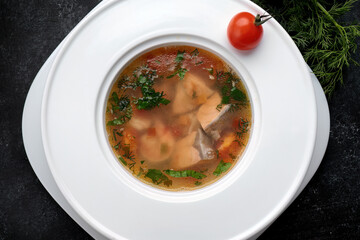 Aromatic red fish soup with tomatoes, garlic and spices