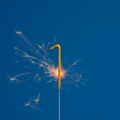 Burning sparkler number 1 - Birthday on blue background